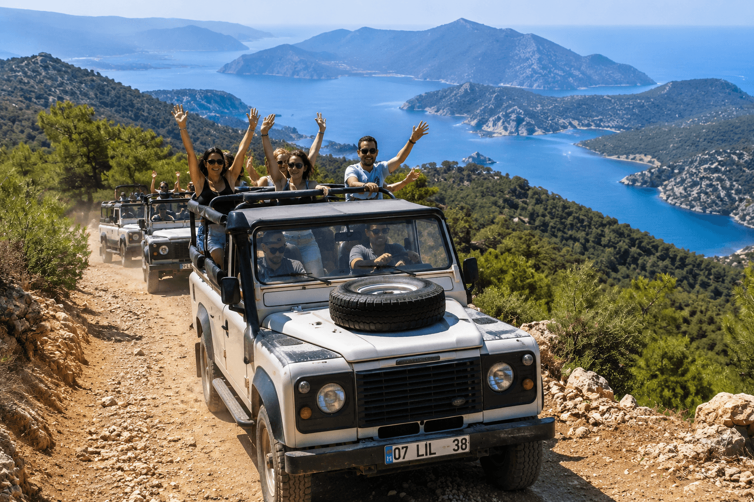 Guests on an open-top jeep safari along a mountain track above the Turkish Mediterranean coast